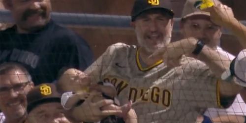 Fan holding a baby snares a foul ball -- and the baby sleeps right through it!